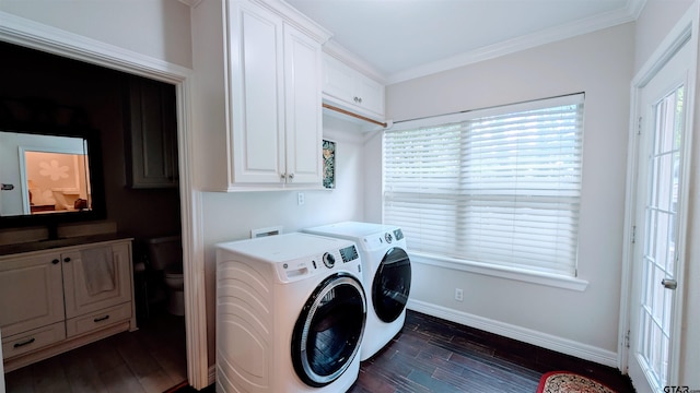 laundry area featuring cabinet space, separate washer and dryer, ornamental molding, baseboards, and dark wood-style floors