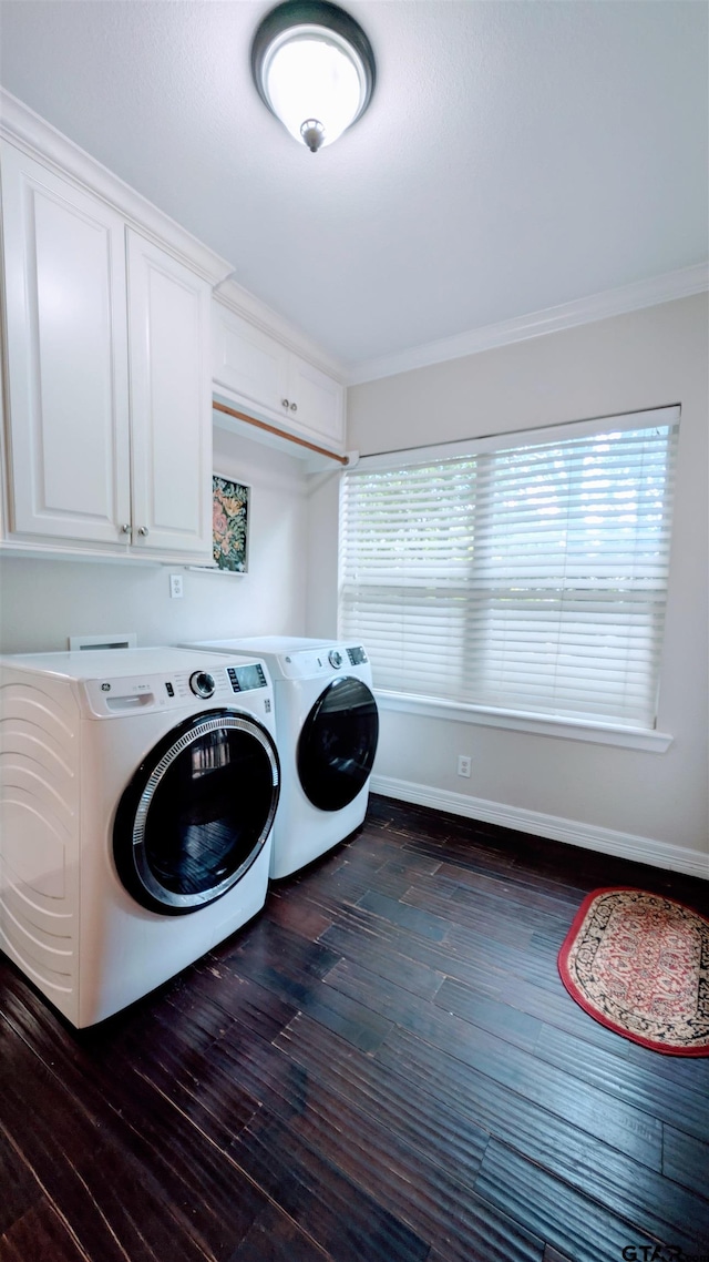 clothes washing area with plenty of natural light, washing machine and dryer, dark wood-style flooring, and cabinet space