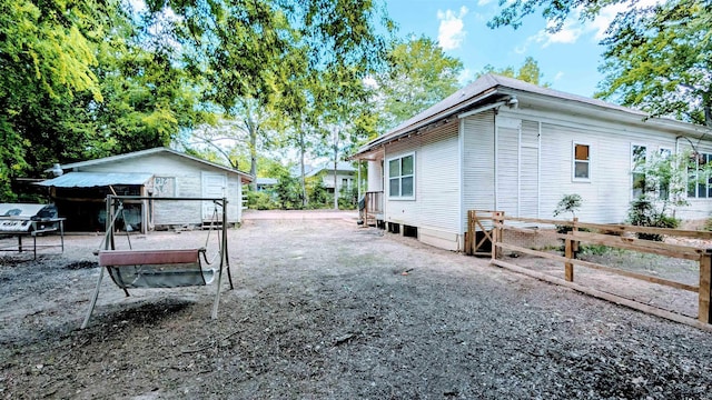 view of property exterior featuring fence and an outdoor structure