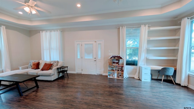 living room with ornamental molding, dark wood-style floors, and a wealth of natural light