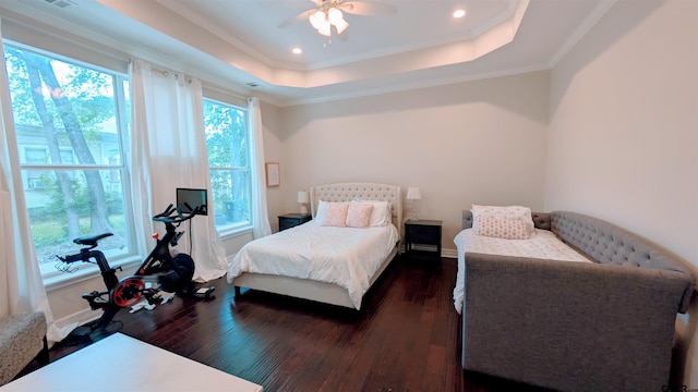 bedroom with recessed lighting, dark wood-style floors, ornamental molding, and a raised ceiling