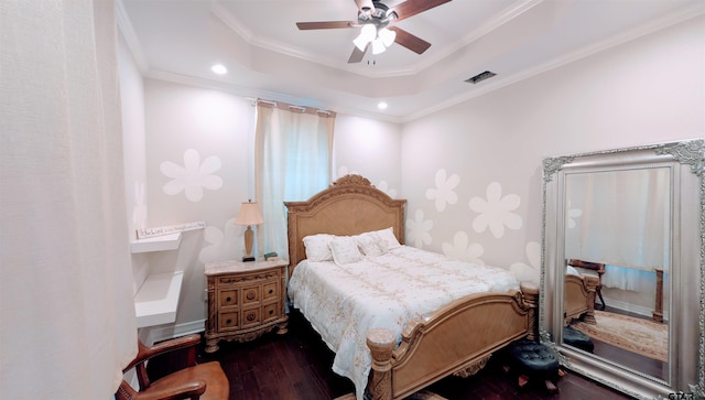 bedroom with dark wood finished floors, recessed lighting, a tray ceiling, visible vents, and ornamental molding