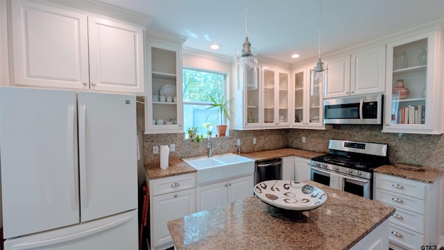 kitchen featuring a center island, a sink, white cabinetry, and stainless steel appliances
