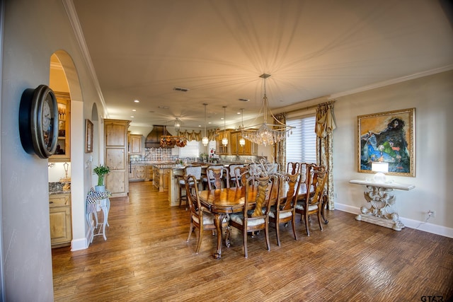 dining space featuring hardwood / wood-style flooring and ornamental molding