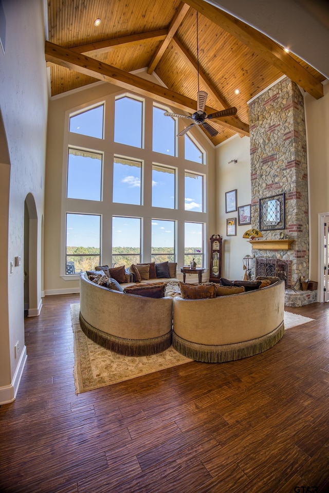 unfurnished living room featuring a fireplace, wood-type flooring, and high vaulted ceiling