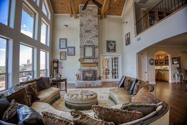 living room with dark hardwood / wood-style floors, high vaulted ceiling, and wood ceiling