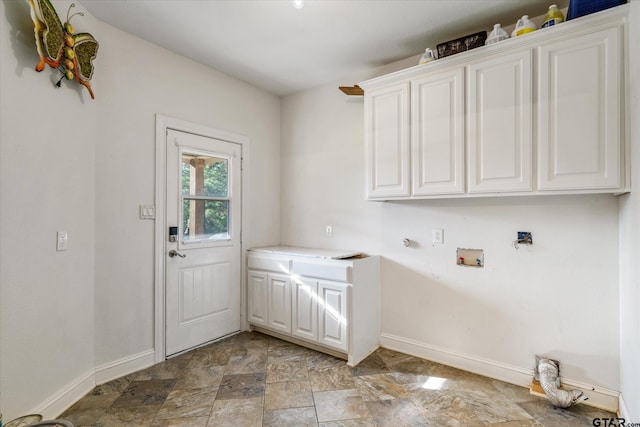 clothes washing area with hookup for a washing machine and cabinets