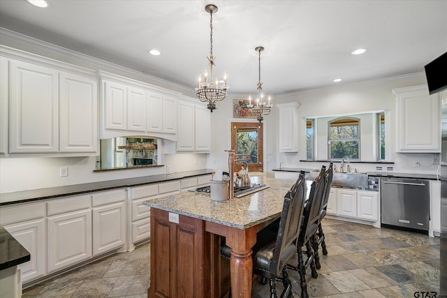 kitchen featuring white cabinets, a center island, stainless steel appliances, and hanging light fixtures