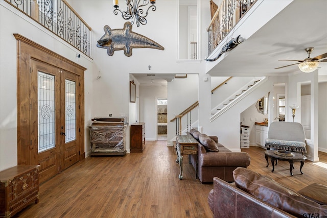 entrance foyer with ceiling fan, a high ceiling, and hardwood / wood-style flooring