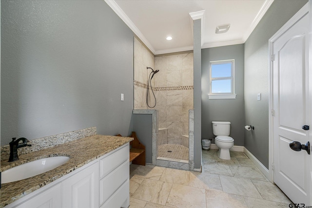 bathroom featuring tiled shower, vanity, toilet, and crown molding