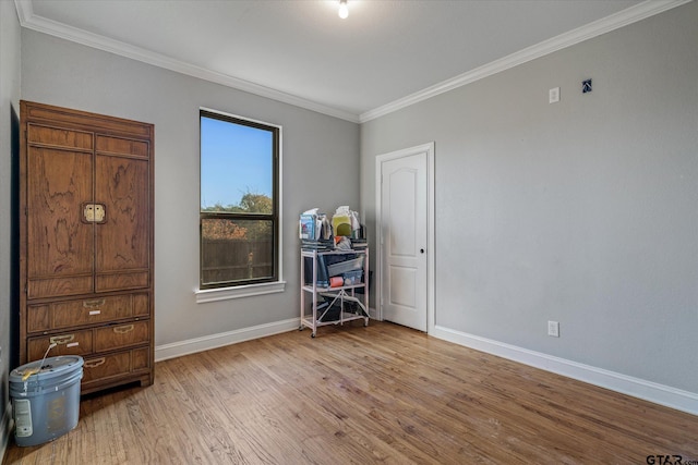 unfurnished bedroom featuring wood-type flooring and crown molding