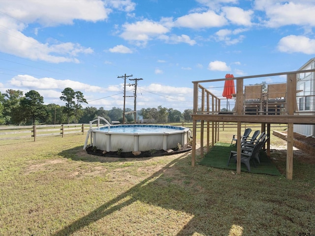 view of yard with a rural view and a swimming pool side deck