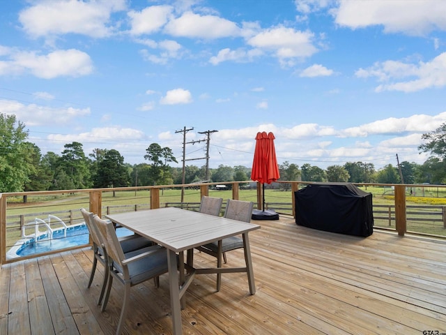 wooden terrace with a grill