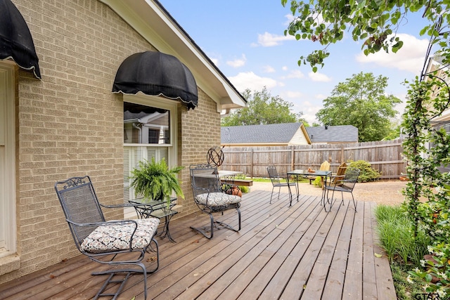 wooden terrace with fence and outdoor dining area