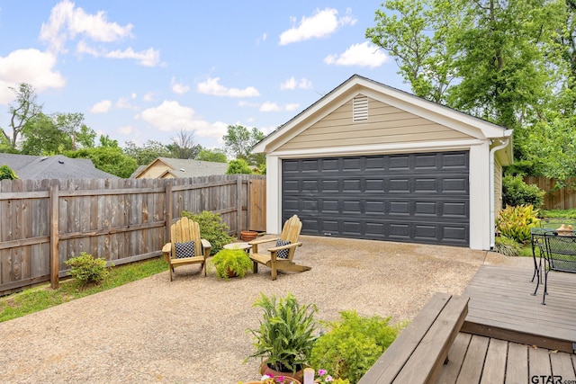detached garage featuring fence
