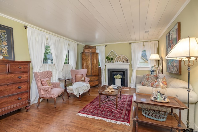 living room with ornamental molding, wood finished floors, and a wealth of natural light