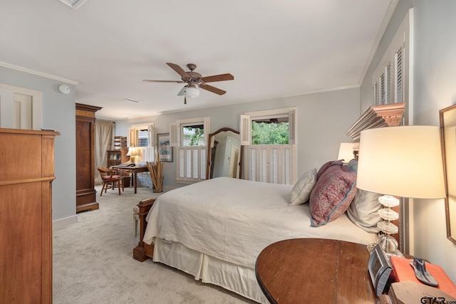 carpeted bedroom featuring baseboards, ornamental molding, and ceiling fan