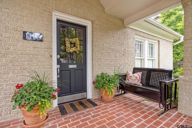 doorway to property with brick siding