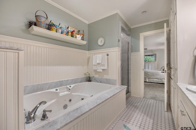 bathroom with a stall shower, a tub with jets, a wainscoted wall, ornamental molding, and ensuite bath
