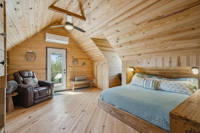 bedroom featuring access to exterior, wooden walls, a wall unit AC, lofted ceiling, and hardwood / wood-style floors