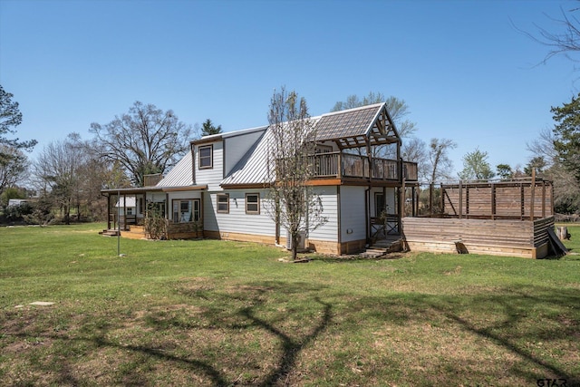 back of property featuring a yard and metal roof