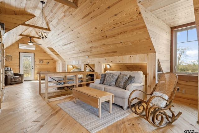 interior space featuring wood ceiling, wood walls, light wood-style floors, and vaulted ceiling