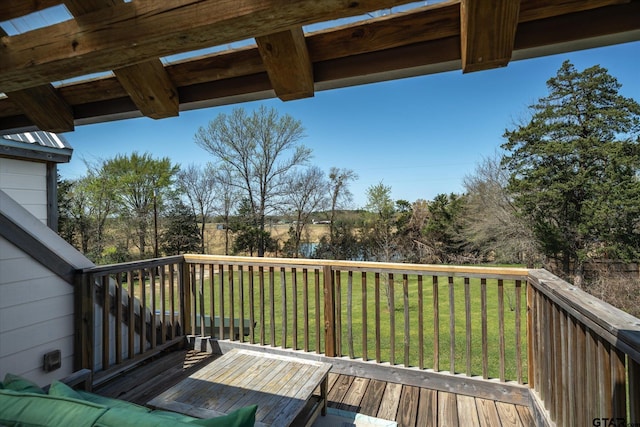 wooden deck featuring a lawn