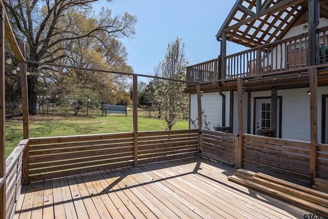 wooden terrace featuring a lawn