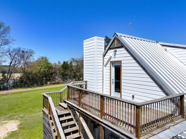 wooden terrace with stairs and a lawn