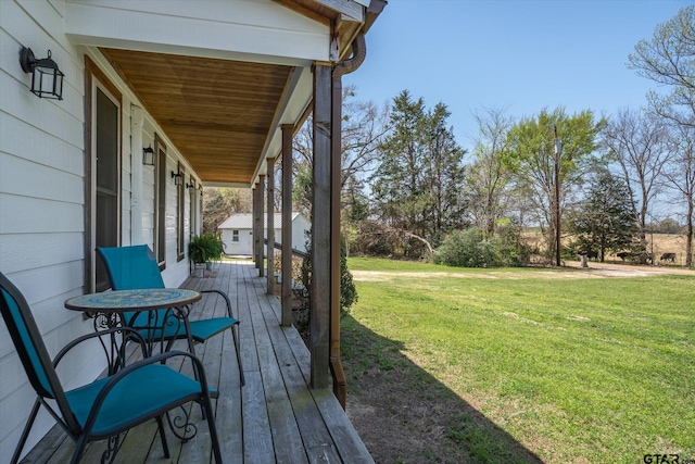 wooden terrace with a lawn