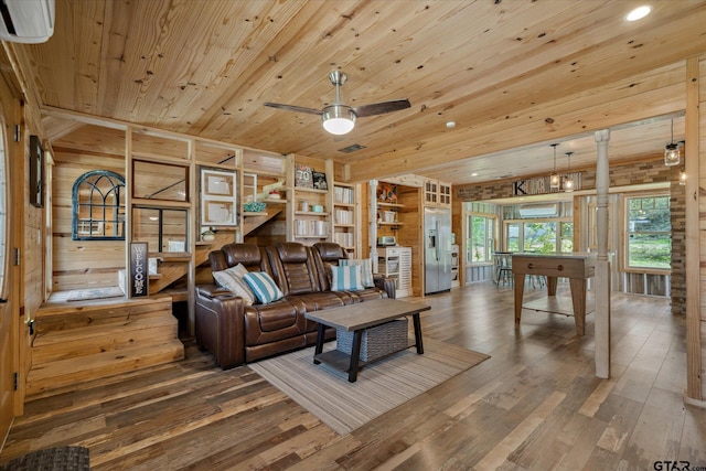 living room featuring a wall mounted AC, wood walls, ceiling fan, hardwood / wood-style floors, and wooden ceiling