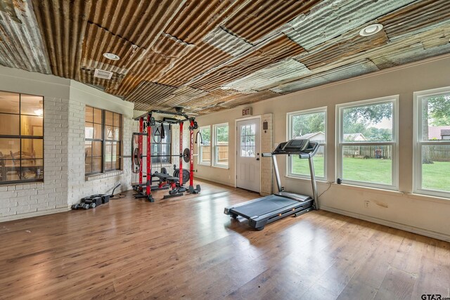 410 Shande St, Whitehouse, TX 75791 - workout area featuring brick wall and wood-type flooring