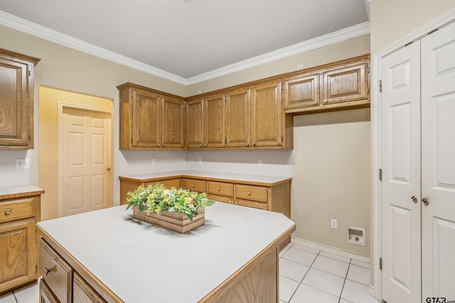 420 Colorado St, Van, TX 75790 - kitchen with light countertops, light tile patterned floors, ornamental molding, and brown cabinets
