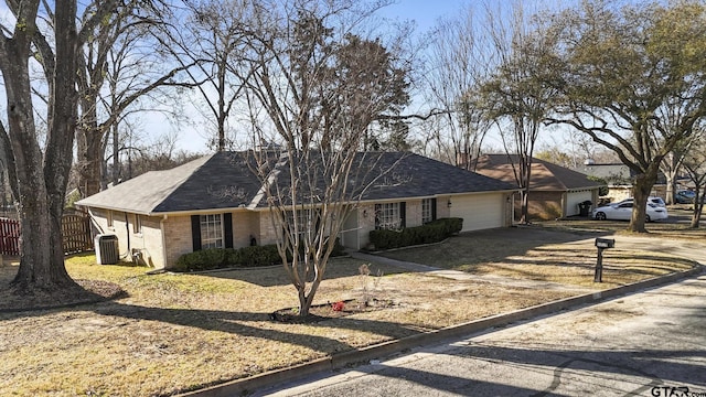 ranch-style house featuring cooling unit, fence, a garage, dirt driveway, and brick siding