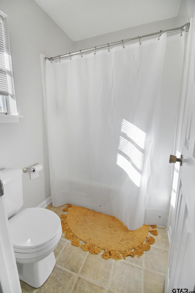 full bath with tile patterned flooring, toilet, and a shower with shower curtain