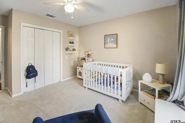 carpeted bedroom with a closet, visible vents, ceiling fan, and baseboards