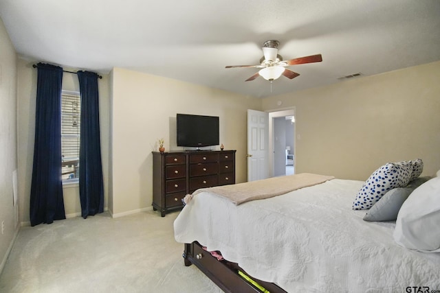 bedroom with a ceiling fan, baseboards, visible vents, and light carpet