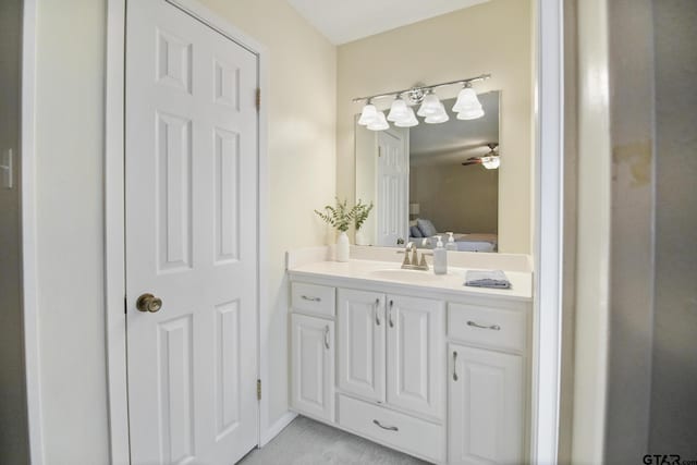 bathroom featuring connected bathroom, vanity, and a ceiling fan