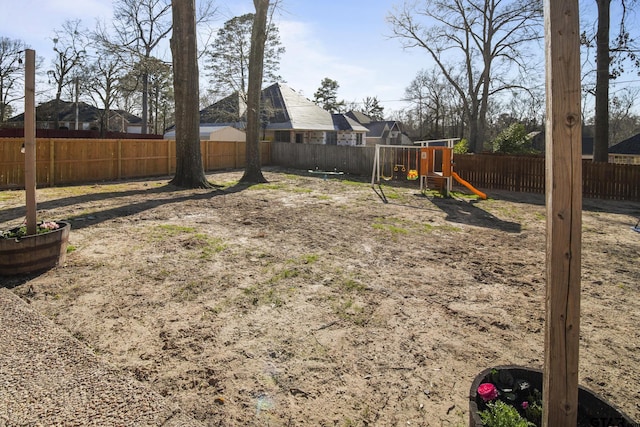 view of yard with a playground and a fenced backyard