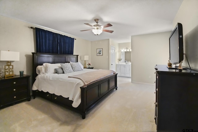 bedroom featuring a ceiling fan, baseboards, ensuite bathroom, and light carpet