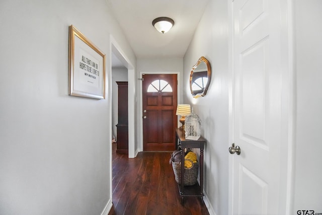 entryway with dark wood-type flooring and baseboards