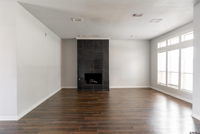 unfurnished living room featuring a fireplace and dark hardwood / wood-style floors