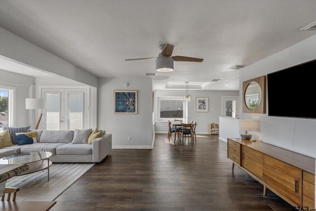 living room featuring french doors, dark hardwood / wood-style flooring, and ceiling fan