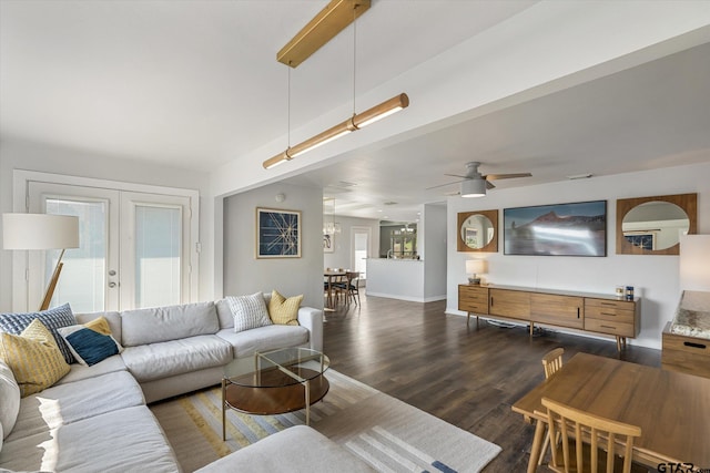 living room with ceiling fan, a healthy amount of sunlight, dark hardwood / wood-style flooring, and french doors