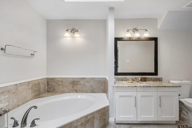 bathroom featuring vanity, toilet, and tiled tub