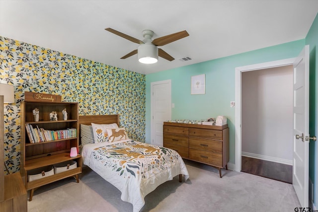 bedroom featuring light colored carpet and ceiling fan