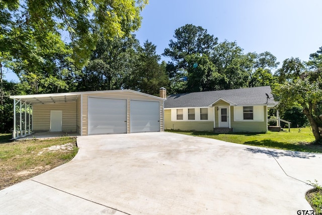 ranch-style home featuring a carport, a garage, and a front lawn