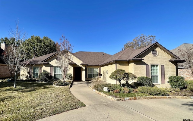 ranch-style home featuring a front yard