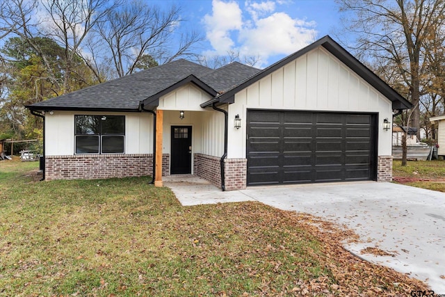 modern farmhouse style home with a front yard and a garage