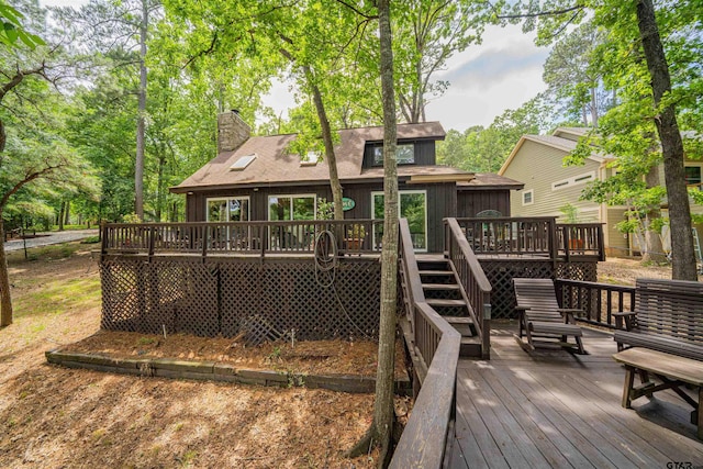 203 King Laurence Ct, Scroggins, TX 75480 - back of property with a chimney, a wooden deck, stairway, and roof with shingles